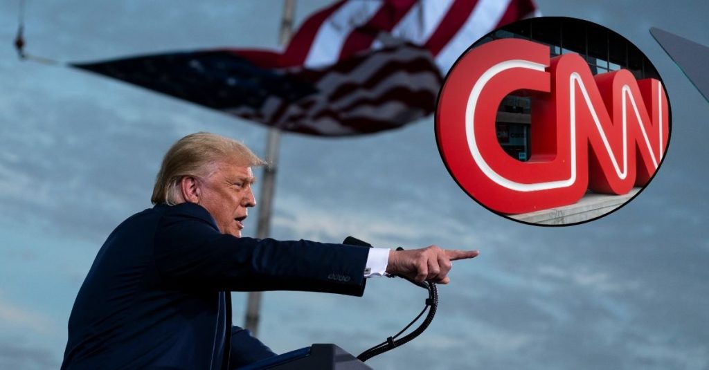 Background: President Donald Trump speaks during a campaign rally at Cecil Airport, Thursday, Sept. 24, 2020, in Jacksonville, Fla. (AP Photo/Evan Vucci). Inset: he CNN logo is displayed at the entrance to the CNN Center in Atlanta on Wednesday, Feb. 2, 2022. (AP Photo/Ron Harris, File)