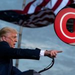 Background: President Donald Trump speaks during a campaign rally at Cecil Airport, Thursday, Sept. 24, 2020, in Jacksonville, Fla. (AP Photo/Evan Vucci). Inset: he CNN logo is displayed at the entrance to the CNN Center in Atlanta on Wednesday, Feb. 2, 2022. (AP Photo/Ron Harris, File)