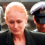 In this Nov. 8, 1999 file photo, Margaret Rudin is escorted by police into Framingham District Court in Framingham, Mass., before her arraignment on charges in connection with the shooting death of her husband. (AP Photo/Michael Dwyer, File; Inset photo is provided by the Nevada Department of Corrections via AP)